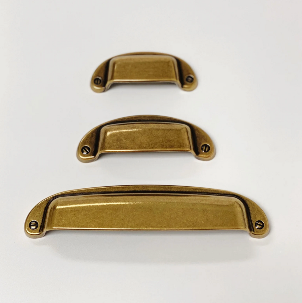 Drawer Cup Pull "Capri" in Antique Brass
