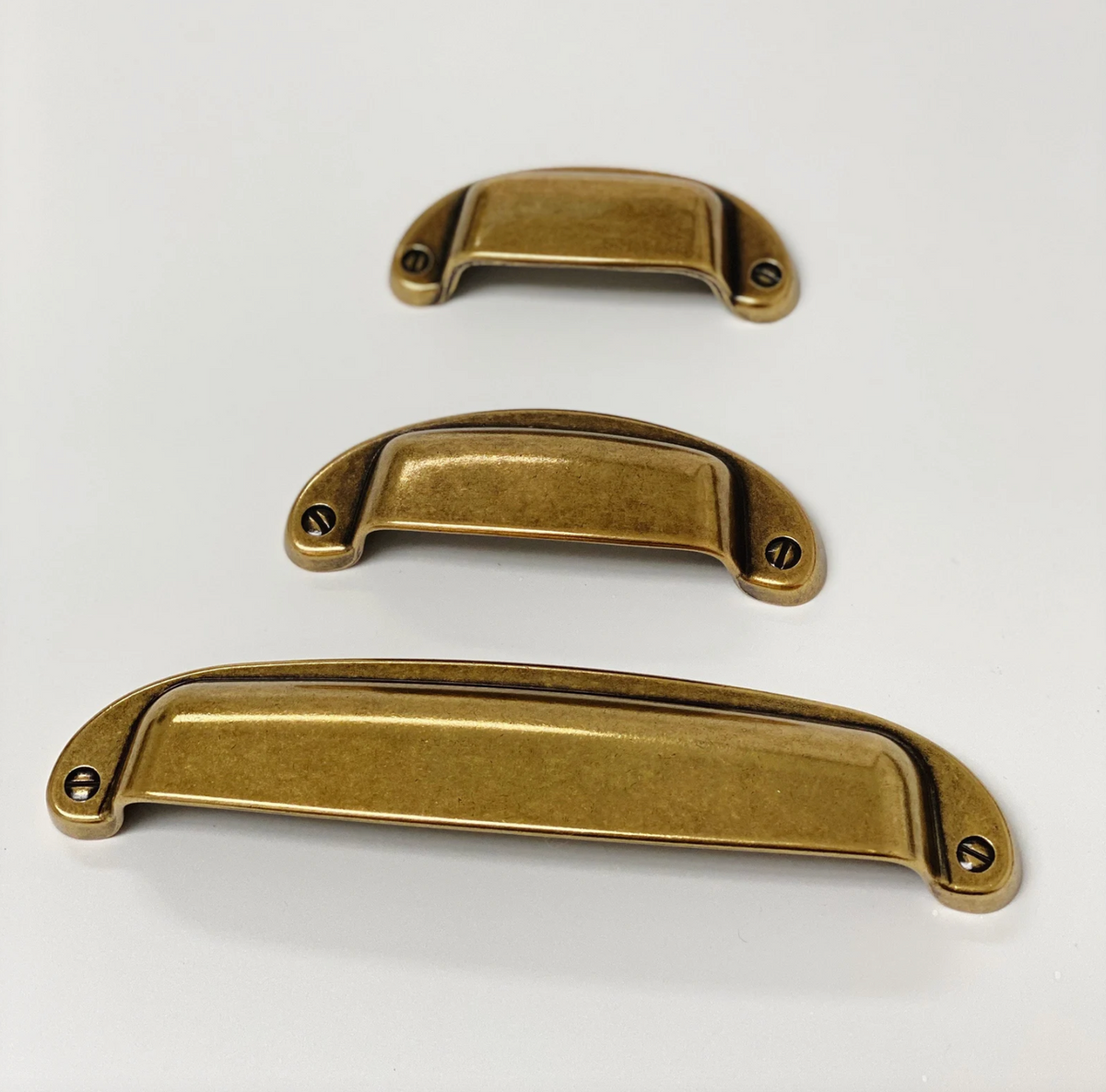 Drawer Cup Pull "Capri" in Antique Brass